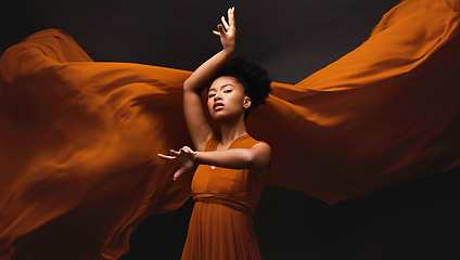 Image showing Black woman, art and fashion, fabric on dark background with dance and aesthetic movement. Flowing silk, fantasy and artistic portrait of serious African model in creative designer dress in studio.