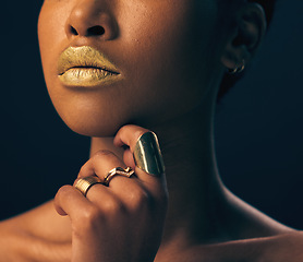 Image showing Closeup, jewelry and black woman with foundation, makeup and grooming against dark studio background. Zoom, female and lady with gold lipstick, rings and cosmetics for skincare, aesthetic and luxury