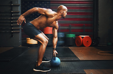 Image showing Fitness, weightlifting and black man with kettlebell in gym training for competition, health and body wellness. Sports, workout and exercise, African American athlete lifting with power and strength.