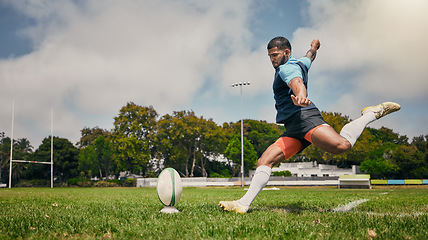 Image showing Rugby, action and man kicking ball to score goal on field at game, match or practice workout. Sports, fitness and motion, player running to kick at poles on grass with energy and skill in team sport.