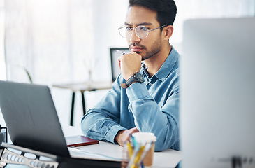 Image showing Serious, business man and thinking on laptop in office, startup company or agency. Focused male employee, computer and solution of inspiration, ideas or planning goals of decision, review or strategy