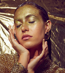 Image showing Gold, woman model and beauty sparkle of a female with makeup and cosmetic glitter. Creative fashion, cosmetics and yellow face glow of a young person with eyeshadow art shimmer and golden sparkles