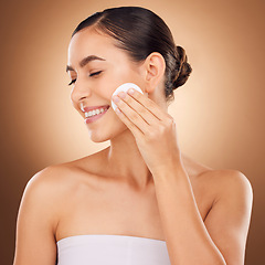 Image showing Skincare, cotton pad and woman face cleaning of a young person with happiness in a studio. Happy smile and dermatology treatment of a female with cosmetics, spa and cosmetology luxury facial