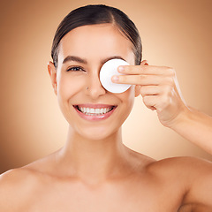 Image showing Portrait, cotton pad and woman with skincare, dermatology and happiness against a brown studio background. Face cleaning, female and lady with cosmetics tool, treatment and grooming to remove makeup