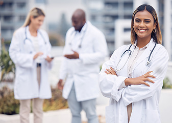 Image showing Healthcare, happy and portrait of a doctor with arms crossed for medicine in the city. Smile, pride and a female Indian medical worker with confidence and empowerment in professional medicare