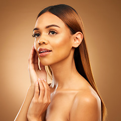 Image showing Woman with hand on face, skin and haircare with bronze glow and luxury salon treatment on brown background. Beauty, makeup and skincare cosmetics, hispanic model with straight hair style in studio.