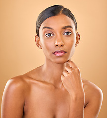 Image showing Serious, beauty and portrait of a woman with makeup isolated on a studio background. Wellness, lifestyle and an Indian model with cosmetics promotion, feminine and looking elegant on a backdrop