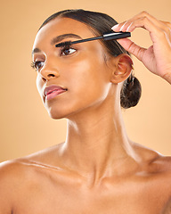 Image showing Mascara, brush and Indian woman, face and beauty, apply makeup product and eyelash extension on studio background. Skin, cosmetology and cosmetic care for lashes, volume and length with cosmetics