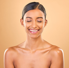 Image showing Beauty, face and smile of woman in studio for skincare, cosmetics, dermatology or makeup. Aesthetic female .laughing for self care, natural skin and spa facial shine results on a brown background