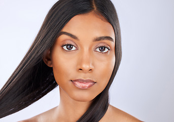 Image showing Hair care, salon and portrait of woman with beauty isolated on a white background in a studio. Serious, young and an Indian model with a keratin treatment, straight and silky hairstyle on a backdrop