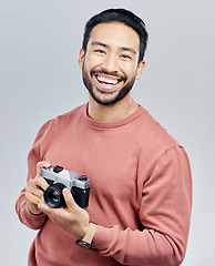 Image showing Portrait, studio and man with camera, tourist and photographer against a grey background. Face, male creative and guy with smile, photography and artist with happiness, memories and capture moment