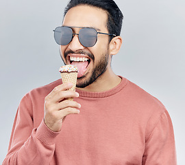 Image showing Ice cream, happy and man in studio with dessert, fun and eating snack against grey background. Cone, sweet and mexican male smile, cheerful and carefree on mockup, space or isolated copy space