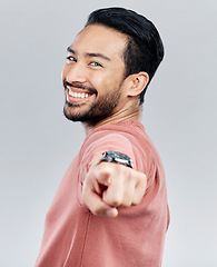 Image showing Pointing, happy and smile with portrait of man in studio for thank you, motivation and amazing. Winner, confident and friendly with male on white background for yes, achievement and satisfaction