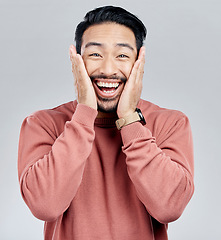 Image showing Portrait, surprise and Asian man excited, wow and happiness against a grey studio background. Face, Japanese male and happy guy with victory, winning and smile with joy, good news and announcement