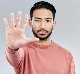 Image showing Portrait, five and hand for stop, Asian man and warning with serious expression against a grey studio background. Face, Japanese male and guy with gesture for halt, raising palm and showing number