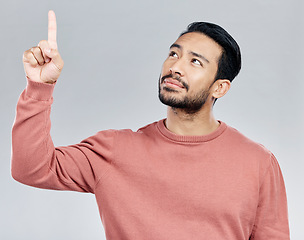 Image showing Promo, announcement and Indian man pointing up with mockup and product placement isolated on white background. Promotion, information and notification space, person in studio with launch idea or info