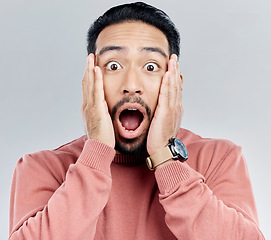 Image showing Portrait, surprise and Indian man with hands on face in shock, wow and omg for announcement in studio. Emoji, meme and excited person with shock for gossip, news or information on white background.