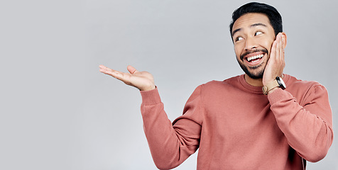 Image showing Product placement, happy and an Asian man showing mockup isolated on a white background. Excited, looking and a guy gesturing to space for branding, advertising and marketing on a studio backdrop