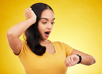 Image showing Late, watch and surprise of a woman in a studio looking at time with alarm feeling shocked. Isolated, yellow background and young female model with shock from watching the clock and smartwatch