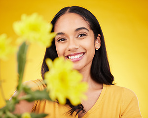 Image showing Flowers, happy and portrait of woman on yellow background with smile, happiness and cosmetics. Spring mockup, beauty and face of girl with floral blossom for nature, aesthetic and natural makeup