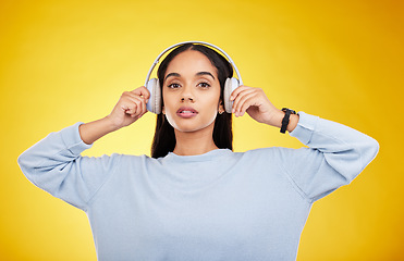 Image showing Music, headphones and portrait of woman in studio for streaming, online radio and audio. Relax, media and podcast with female isolated on yellow background for technology, listening and connection