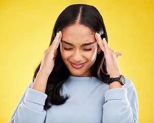 Image showing Young woman, stress and headache with pain and distress, frustrated and agony on yellow studio background. Female massage temple, mental health and anxiety with depression, migraine and trauma