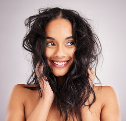 Image showing Hair, happy with woman and beauty, messy hairstyle and cosmetics on studio background. Wellness, shine and female smile, face and cosmetic care, keratin treatment and texture with volume and growth