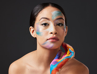 Image showing Woman, face and beauty portrait with color paint art on hand in studio. Creative skin and makeup on female aesthetic model on gray background for lgbtq rainbow inspiration hands or facial cosmetics