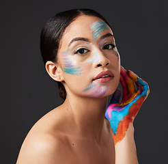 Image showing Woman, portrait and beauty with rainbow makeup art on hand and face in studio. Creative skin and facial cosmetics on female aesthetic model on gray background for lgbtq color inspiration on hands