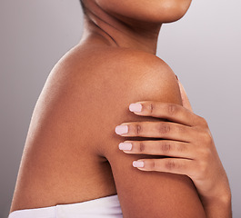 Image showing Woman, hands and shoulder in skincare beauty, cosmetics or body care against a gray studio background. Hand of female touching shoulders in cosmetic treatment for self love or soft and perfect skin