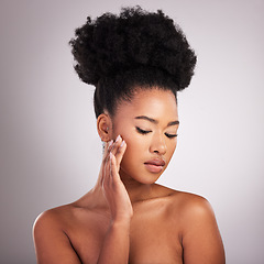 Image showing Skincare, beauty and black woman with hand on face, white background and cosmetics. Health, dermatology and natural makeup and African model in studio space for healthy skin care and wellness.