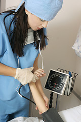 Image showing Doctor measureing blood pressure