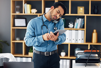 Image showing Call, tablet and telehealth by confused doctor using technology for medical communication or consulting online. Digital, unsure and man healthcare professional typing and on phone conversation