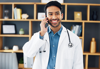 Image showing Asian man, doctor and phone call with smile for healthcare consulting, conversation or chat at hospital. Happy male medical expert smiling on mobile smartphone in communication or health consultation