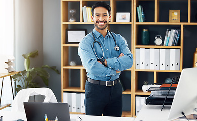 Image showing Portrait, man and doctor with arms crossed, hospital and confidence with smile, proud of career and employee. Face, medical professional and male consultant with medicine, wellness and development