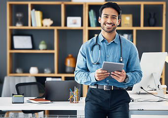 Image showing Smile, tablet and portrait of doctor in office using the internet or web for medical search online, confident and satisfied. Man healthcare professional or GP holding digital device for communication