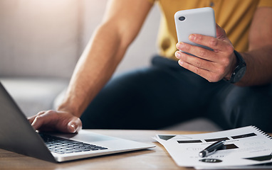 Image showing Hands, laptop and phone with man in the living room, sitting on a sofa in his home for future growth planning. Computer, research and smartphone with a male browsing the internet for information