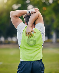 Image showing Back, fitness and man stretching, training and outdoor for workout, exercise and sports for wellness. Male athlete, guy and player stretch arms, soccer and practice for competition, match and health