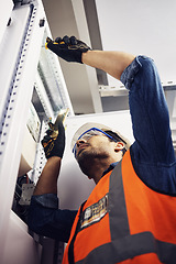 Image showing Engineer, electrician and maintenance man with screwdriver in control room for power box. Male technician person for inspection service for engineering, electricity or energy supply repair with torch