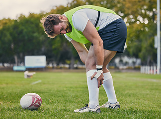 Image showing Rugby, pain and man with legs injury on sports field after practice match, training and game outdoors. Medical emergency, accident and male athlete with joint inflammation, knee sprain and tendinitis