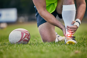 Image showing Rugby, pain and man with foot injury on sports field for practice match, training and game on grass. Medical emergency, accident and male athlete with joint inflammation, ankle sprain and tendinitis