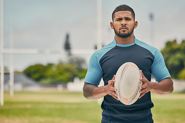 Image showing Rugby, field and portrait of man with ball, serious expression and confidence in winning game. Fitness, sports and player training for match, workout or competition on grass at stadium with mockup.