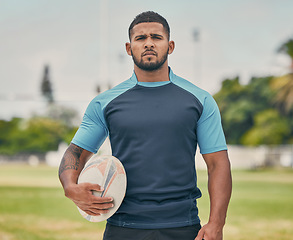 Image showing Rugby, ball and portrait of tough man on field with serious expression, confidence and pride in winning game. Fitness, sports and player ready for match, workout or competition on grass at stadium.