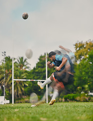 Image showing Rugby, motion and man kicking ball to score goal on field at game, match or practice workout. Sports, fitness and action, player running to kick at poles on grass with energy and skill in team sport.