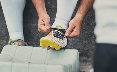 Image showing Rugby, tie shoes or sports man ready to start playing a training game for cardio exercise or workout. Zoom, fitness or hands of athlete player with footwear or boots in outdoor stadium in France