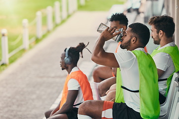 Image showing Team, rugby men and fitness on bench with drinking water, relax or sitting with diversity, solidarity or health. Group teamwork, university or professional sports at stadium for game, friends or goal