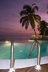 Image showing luxury infinity swimming pool caribbean sunset