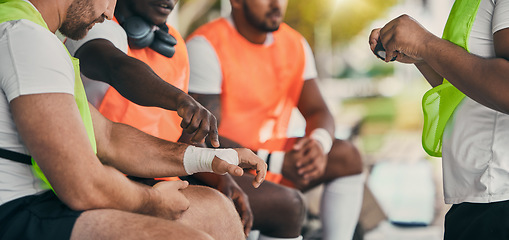 Image showing Injury, sports and a man with a bandage at rugby, wrapping wrist and accident at a game. Team, playing and men protecting a hand of a player after a broken bone during sport competition or match