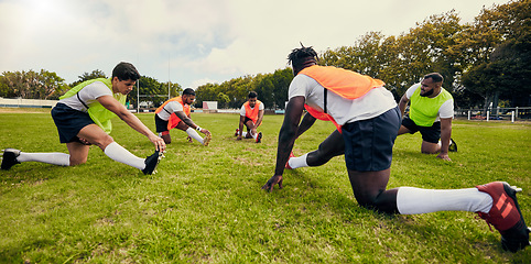 Image showing Sports, training and men outdoor for rugby on grass field with diversity team stretching as warm up. Athlete group together for fitness, exercise and workout for professional sport or teamwork energy