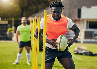 Image showing Rugby, sports and black man training with equipment ready for match, practice and sport game. Fitness, performance and serious male athlete with ball for warm up, exercise and workout for competition